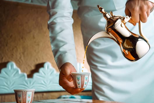 Arabic coffee poured from a dallah