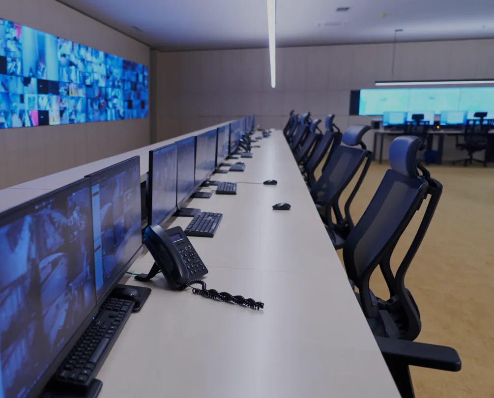 Network server racks glowing blue inside a modern datacenter representing Technology and ICT Security